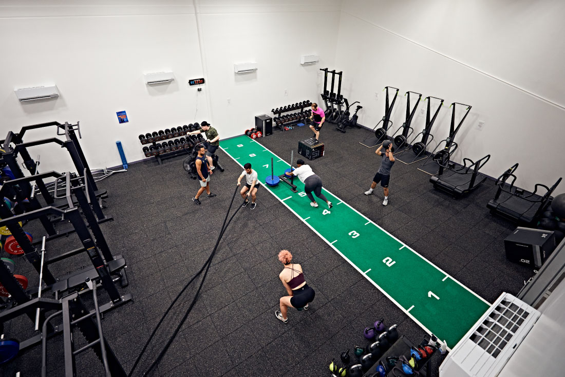 People working out with different equipment in performance suite