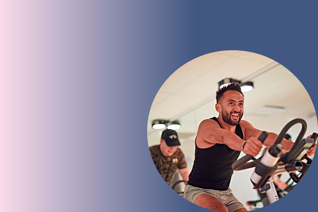 Person smiling while exercising in spinning class
